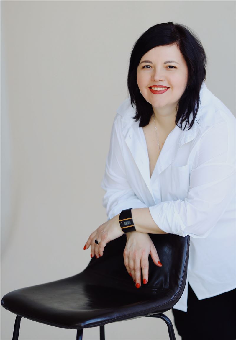 Ірина Савенко, бухгалтерка експертів, усміхається в білій сорочці